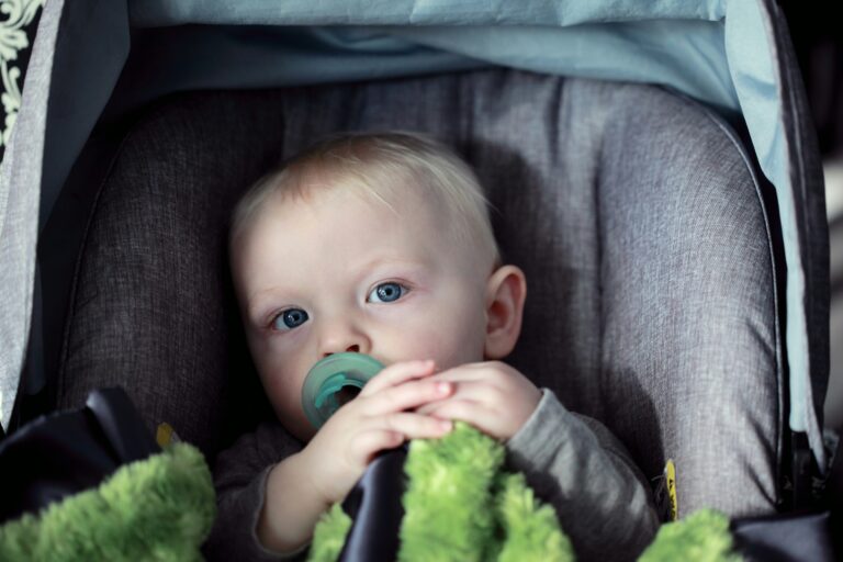 boy in car seat with pacifier